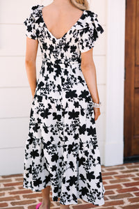 Black and white floral midi Ruffled detailing Smocked bust and waist Perfect for summer date nights or parties Chic, versatile style.