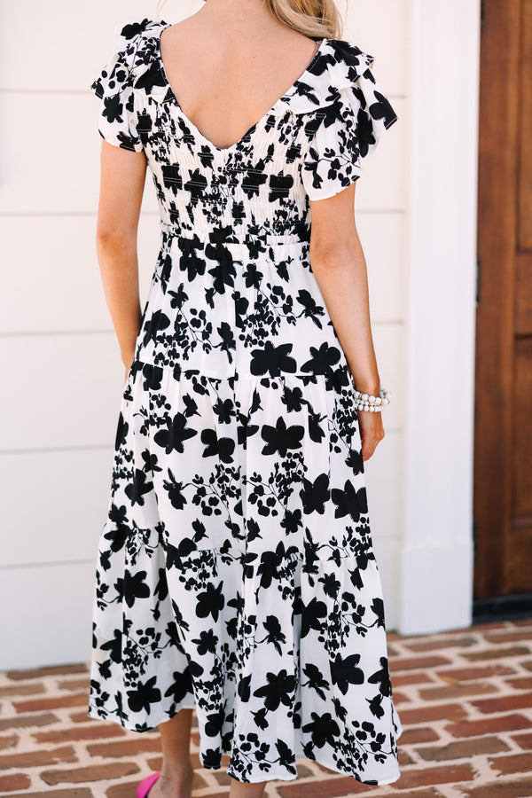 Black and white floral midi Ruffled detailing Smocked bust and waist Perfect for summer date nights or parties Chic, versatile style.
