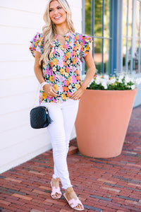 Black blouse with floral print Vibrant color infusion Ruffled sleeves Unique style statement Whimsical fashion