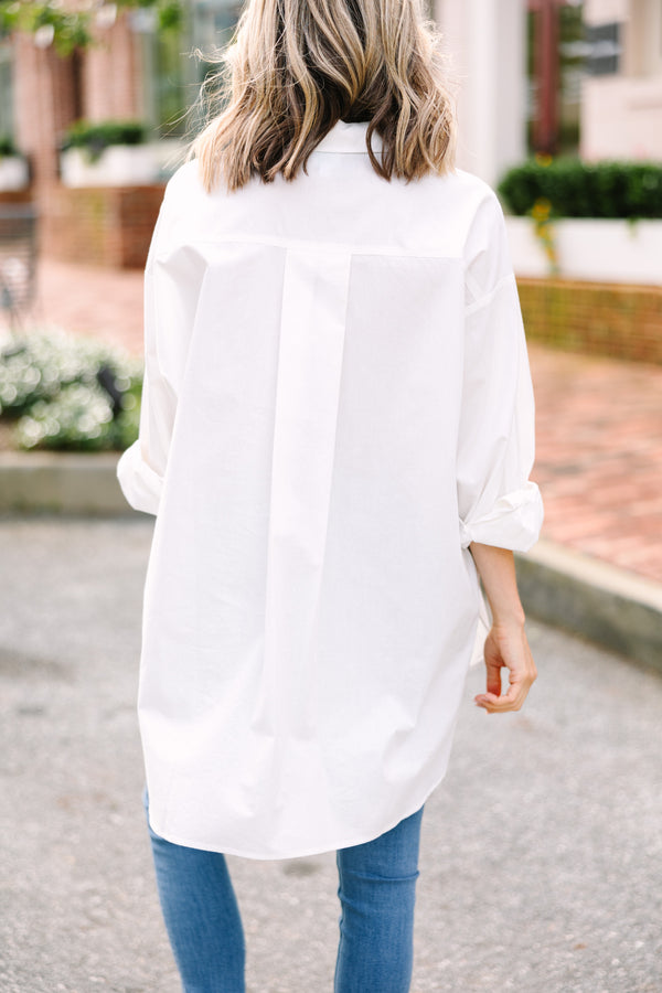 Cotton button-down white top Oversized fit High-low hemline Perfect with jeans or as a coverup Casual chic style