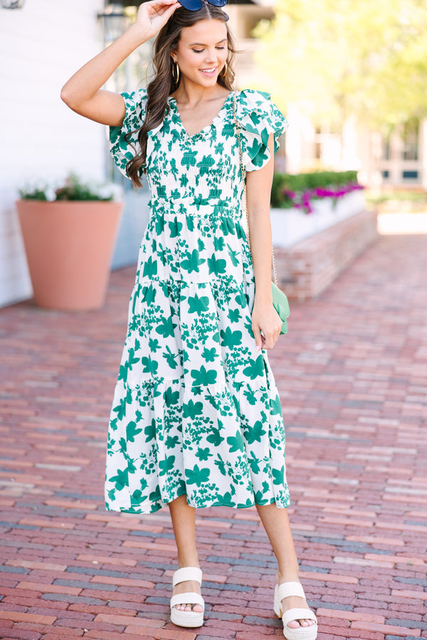 Green and white floral midi dress Short ruffled sleeves Smocked bust and elastic waist Perfect for date nights or brunch Trendy, versatile style.