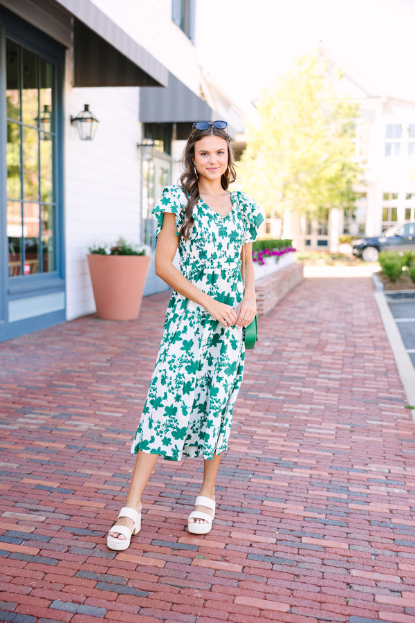 Green and white floral midi dress Short ruffled sleeves Smocked bust and elastic waist Perfect for date nights or brunch Trendy, versatile style.