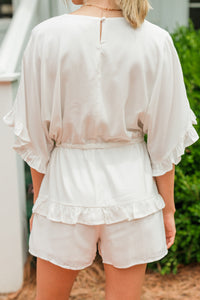 white ruffled romper