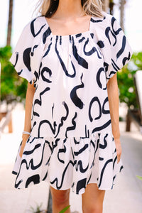 cream and black abstract print dress with short puff sleeves