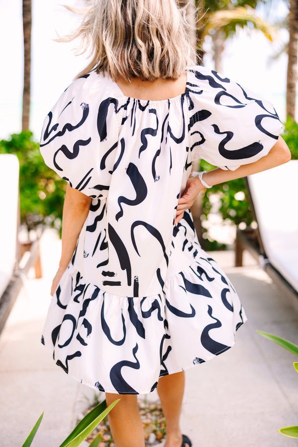 cream and black abstract print dress with short puff sleeves
