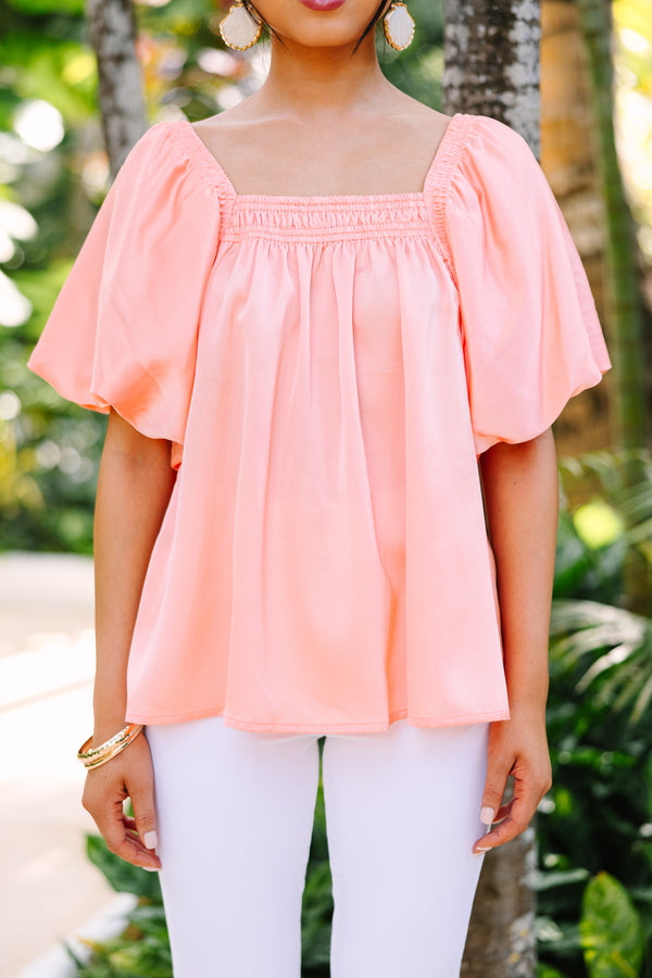 peach satin blouse with puff sleeves and square neckline
