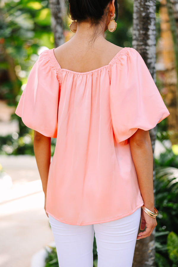 peach satin blouse with puff sleeves and square neckline