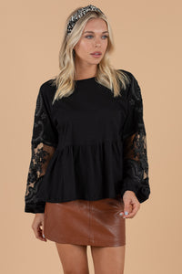 round neckline, long, lace sleeves, and a peplum detail. 