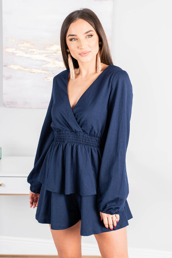 long, bubble sleeves, a v-neck surplice neckline, a smocked waist, tiered detailing