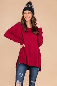 red top, red waffle top, top, waffle knit fabric, long sleeves, split sides, round neckline, high low hem, layer, casual