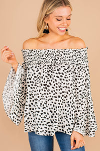 top, white, smocked off the shoulder neckline, spotted leopard print, long bell sleeves, chic