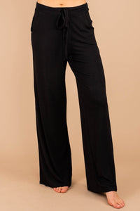 soft stretch fabric, pants, black pants, tied front waist, pockets, wide leg hem, palazzo pants