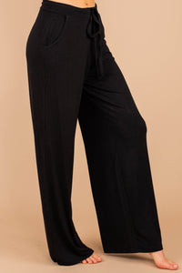 soft stretch fabric, pants, black pants, tied front waist, pockets, wide leg hem, palazzo pants