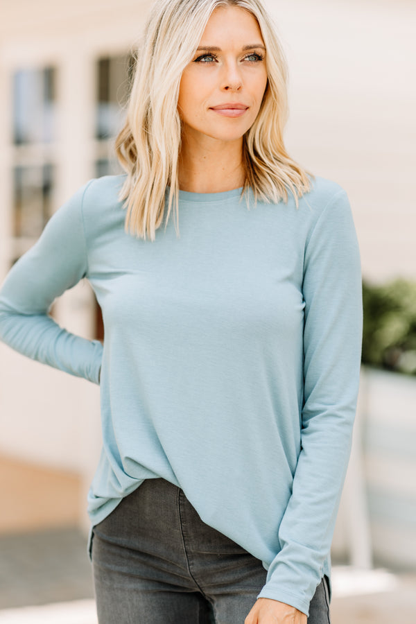 long sleeves, a round neckline, and a classic fit