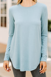 long sleeves, a round neckline, and a classic fit