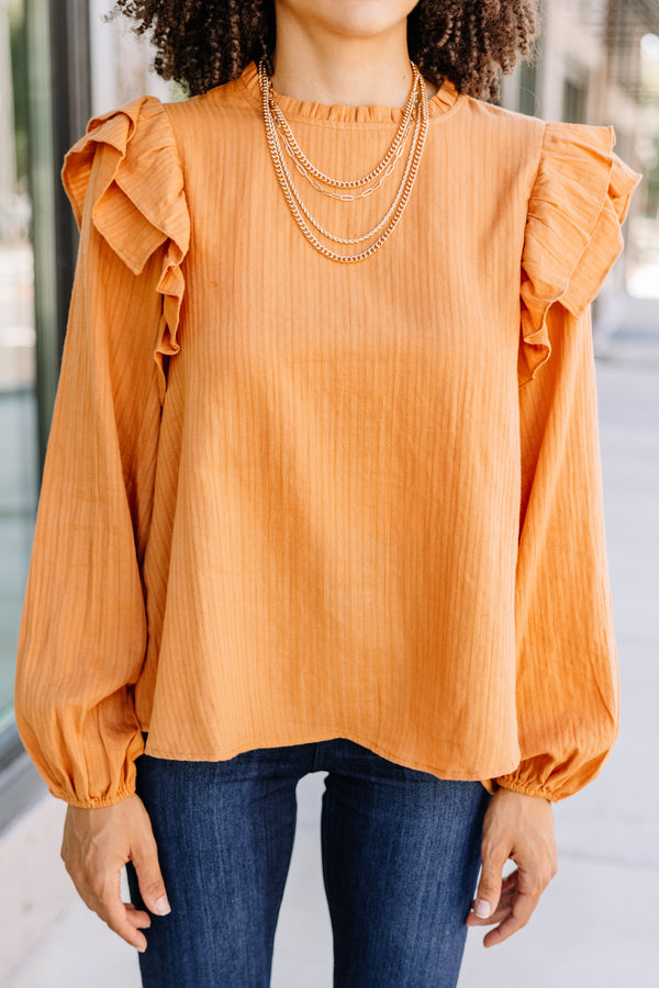 ruffled orange blouse