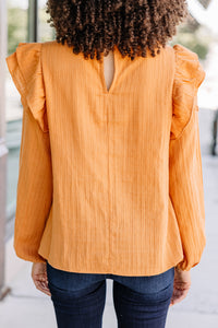 ruffled orange blouse