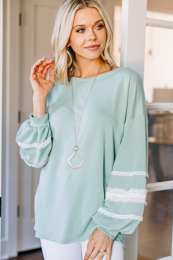 green long sleeve top with lace detailing