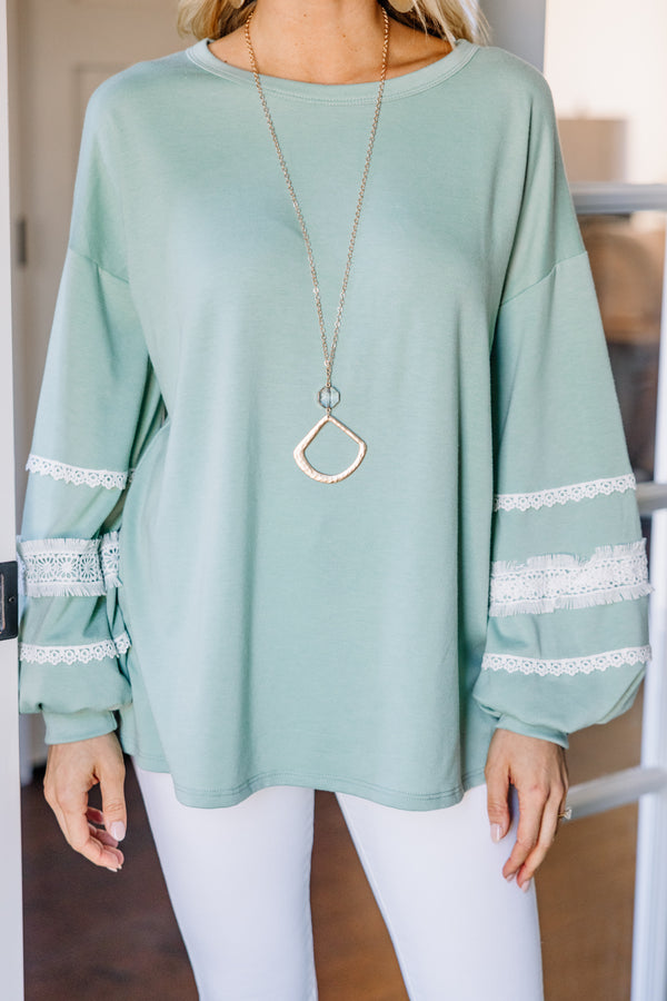 green long sleeve top with lace detailing